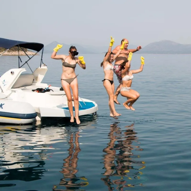 A corporate team taking part in a hands-on beach cleanup along the Croatian coast